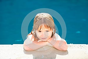 Portrait of little boy in swimming pool. Concept of kids face. Head shoot children portrait. Kid relax in pool side.