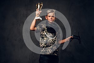Portrait of little champion with cup in his hands