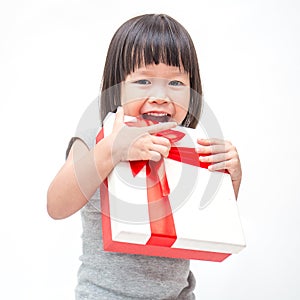 Portrait of little cute asian girl holding box of Christmas present