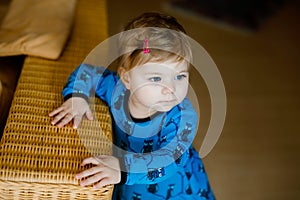 Portrait of little cute baby girl learning walking and standing. Adorable toddler girl at home. Beautiful baby child in