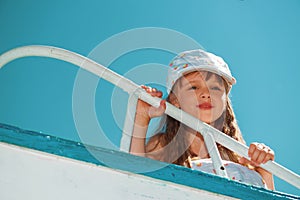 Portrait of little cute girl enjoying playing on boat
