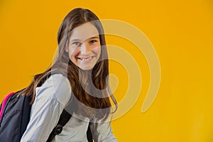 Portrait of little cute girl schoolgirl with backpack