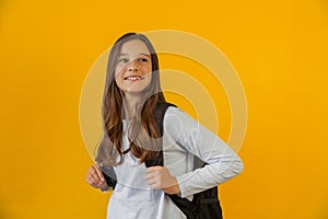 Portrait of little cute girl schoolgirl with backpack