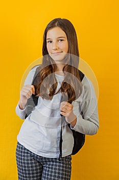 Portrait of little cute girl schoolgirl with backpack