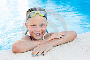 Portrait of little cute girl in the swimming pool.