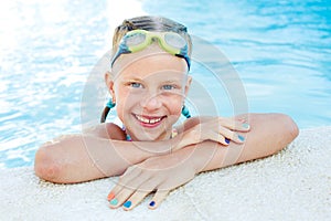 Portrait of little cute girl in the swimming pool.