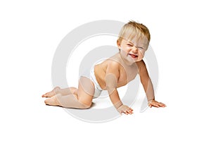 Portrait of little cute toddler boy, baby in diaper crawling isolated over white studio background. Making faces