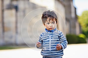 Portrait of a little eastern handsome baby boy playing outdoor in the park