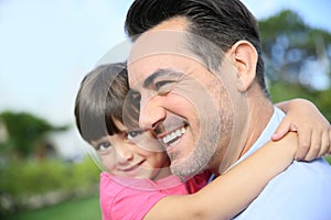 Portrait of little girl in the arms of her father