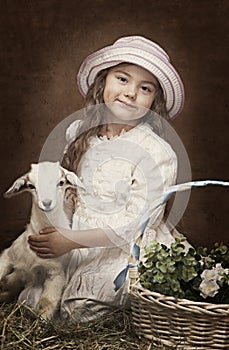 Portrait of a little girl with a baby goat