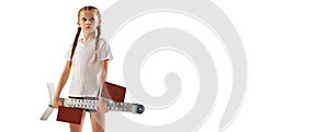 Portrait of little girl, beginner athlete in sportswear posing with starting blocks isolated over white background