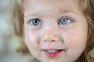 Portrait of a little girl with big blue eyes