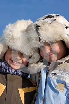 Portrait of little girl and boy in the fur-cap