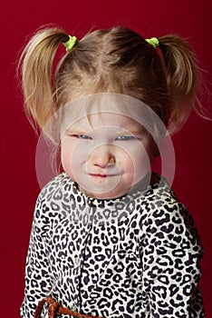 portrait of little girl with bright facial expressions, she is angry and pouting