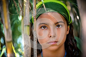 Portrait of a little girl in the bushes