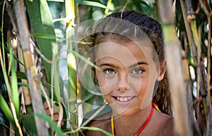 Portrait of a little girl in the bushes