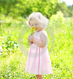 Portrait little girl child with flowers in spring