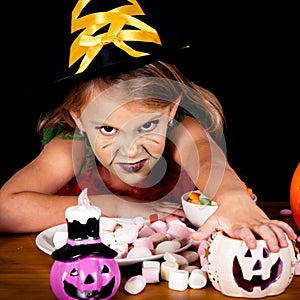 Portrait of little girl in costume witch on Halloween