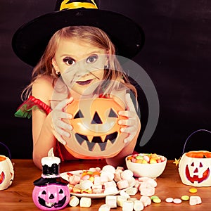 Portrait of little girl in costume witch on Halloween