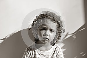 Portrait of little girl with curls on white background.