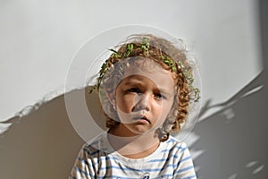 Portrait of little girl with curls on white background.