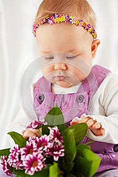 Portrait of little girl dressed in violet pinafore dress photo