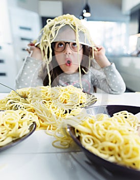 Portrait of a little girl eating a spaghetti pasta