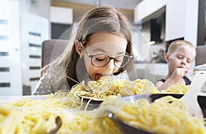 Portrait of a little girl eating a spaghetti pasta