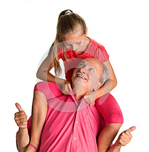 Portrait of a little girl enjoying piggyback ride with her grand photo