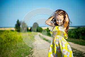 Portrait of a little girl in a field.