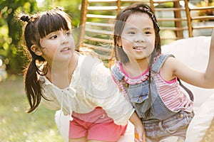 Portrait little girl with friends. cute kid in nature park.