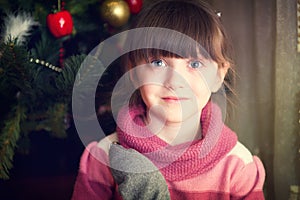 Portrait of little girl in front of Christmas tree