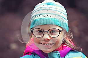 Portrait of little girl in glasses for sight in outdoor