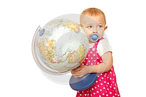 Portrait of little girl with globe in hands, on it