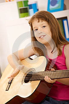 Portrait of little girl with guitar