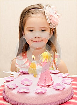 Portrait of little girl and her birthday cake