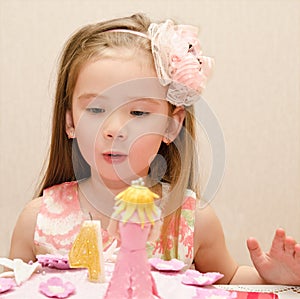 Portrait of little girl and her birthday cake