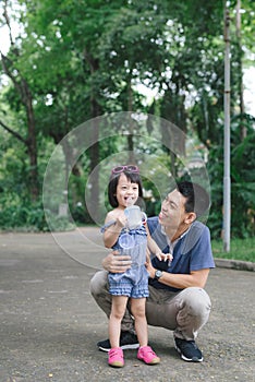 Portrait of little girl hugging her daddy with nature, family concept