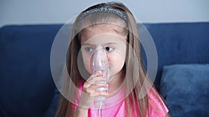 Portrait of little girl in an inhalation mask.
