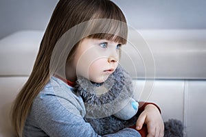 Portrait of little girl, Kid sad face sitting alone in the room,