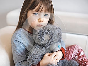 Portrait of little girl, Kid sad face sitting alone in the room,