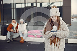 Portrait of a little girl with passports and her parents behind