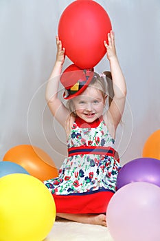 Portrait of a little girl playing with balls