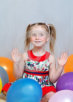 Portrait of a little girl playing with balls