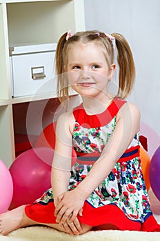 Portrait of a little girl playing with balls