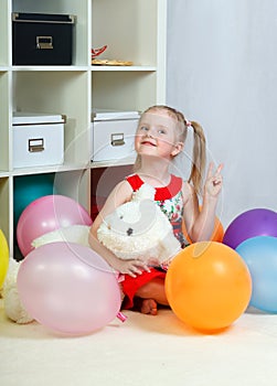 Portrait of a little girl playing with balls