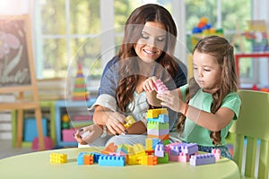 Portrait of a little girl playing with mother