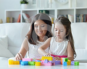 Portrait of a little girl playing with mother