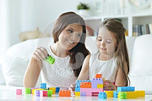 Portrait of little girl playing with mother