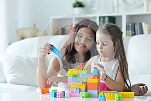 Portrait of little girl playing with mother